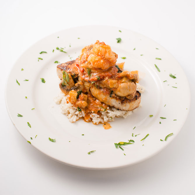Cajun Grilled Swordfish with shrimp mushrooms eggplant in a basil wine sauce over risotto